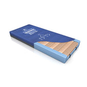 Blue and white eraser with a brown sleeve on a textured mattress-like surface, close-up.