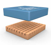 Blue rectangular Dyna-Pad Cushion on tan cylinders, for pressure ulcer prevention, angled view.