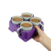 Light grey recycled plastic tray holding four mugs, shown in hand against a white background, in use view.