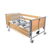 Woburn Community Bed with metal slats, wooden panels, side rails and wheels, side view.