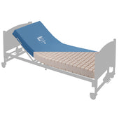 Wide contour foam mattress with raised head area in a semi-transparent bed frame, angled side view.