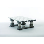 White and grey plastic rectangular bath seat with four legs, slatted top for drainage, small size, angled view.