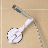 Drive shower head holder with flexible hose attached to beige tiled wall using suction cup, side view.