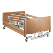 Sidhil Bradshaw wide nursing care bed in light oak with electric backrest, metal side rails and wheels, 3ft 10in platform, front angle view.