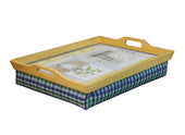 Wooden lap tray with cutout handles, printed surface and blue-green plaid cushion base, angled front view.