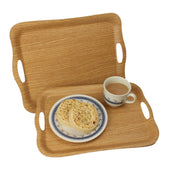 Pair of Lifemax non-slip trays, one with tea and crumpets, one empty in the background, angled view.