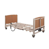 Sidhil Solite Pro Electric Bed with metal frame, wooden ends, wheels, control panel and full-length side rails, side view.