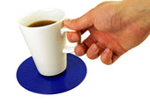 Hand picking up white coffee cup from red non-slip coaster, white background, in use view.