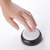 Hand pressing round white talking button clock with black base, Ravencourt brand, in use view.