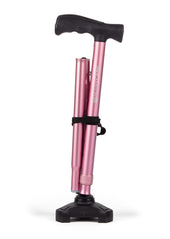 Pastel pink walking stick with black handle, base and strap, upright on white background, front view.