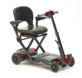 Blue Drive auto folding scooter with padded seat, armrests and four wheels, compact and lightweight design, side view.