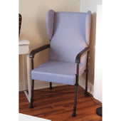 Cream high back chair with black frame and lumbar support, placed by a desk and white lamp, front angle view.