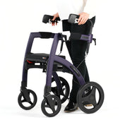 Person behind purple Rollz Motion 2 rollator and wheelchair with large wheels and compact frame, in use rear view.