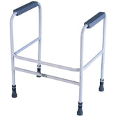 White and grey height adjustable toilet frame with padded armrests and rubber-tipped legs, front view.