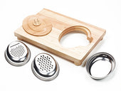 Easi-Grip food preparation board with round opening, two metal grater inserts, lid, and metal bowl on white background, top view.