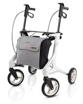 White four-wheel Topro Pegasus Carbon rollator with hand brakes and a grey front storage bag, front view.