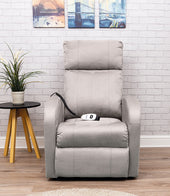 Light grey Aidapt Daresbury single motor riser recliner chair with remote on seat, next to small table and plant, front angle.