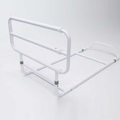 White metal bed rail with flat base for added support, positioned next to a bed, side view.