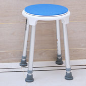 Blue swivel shower stool with adjustable silver legs and suction cups, shown on tiled floor, side view.