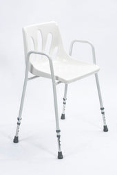 White adjustable height shower chair with moulded seat, armrests and rubber-tipped legs, front angle view.