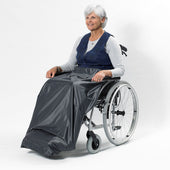 Older woman in wheelchair with NRS Freestyle Wheelchair Apron covering her legs and feet, in use front view.