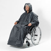 Person in a wheelchair wearing a grey NRS Freestyle Wheelchair Mac with reflective piping, front view.