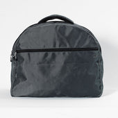 Black waterproof wheelchair dropover bag with zippered front pocket and top handle, front view.