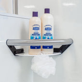 Elegance Shower Shelf Grab Rail holding two shampoo bottles, white bath pouf hanging on the rail, close-up view.