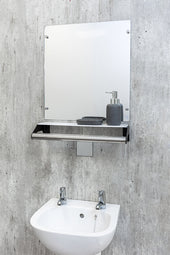 Mirror shelf grab rail above white sink with two taps and soap dispenser on grey wall, front view.