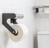 Wall-mounted Elegance Toilet Roll Holder with one roll on the holder and another roll on a shelf, side view.