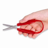 Hand holding red round-ended Easi-Grip Mini scissors with stainless steel blades, white background, in use view.