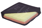Reflect Cushion with dark cover, partially unzipped to reveal yellow and pink layered foam inner, close-up view.