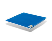 Blue Harvest Healthcare gel cushion with white corner label, placed on a white surface with visible shadow, angled top view.