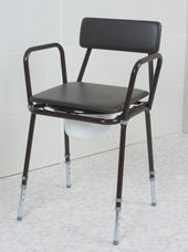 Adjustable height commode with black frame, armrests, padded seat and back, removable white bucket, front view.