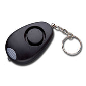 Personal alarm with circular button, small silver keyring and built-in LED torch, front view.