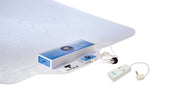 Texible Wisbi sensor mat with blue control boxes for detecting incontinence and bed exits, top view.