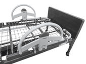 Stander EZ Click Bed Rail in black and white with metal spring base and wooden headboard for hospital bed, side view.