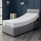 26 Restwell Richmond II electric bed with reflex foam mattress elevated in a blue panelled bedroom, side view.