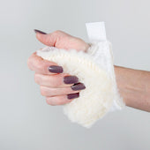 Hand holding a Thorpe Mill Palm Protector mitt to prevent nail damage, plain background, in use view.