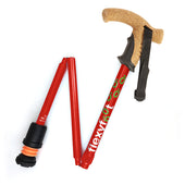 Orange folding walking stick with cork handle, black grip and Flexyfoot ferrule, side view.