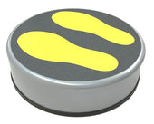 Rotunda Raising Block with round button, two yellow footprints on dark surface for transfer guidance, top view.