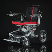 Motion Healthcare Aerolight Trekker powerchair with joystick control and black-red seat, airline-approved battery, angled side view.