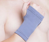 Kedley Active Elasticated Hand Support on right hand, fist gently clenched, in use view.