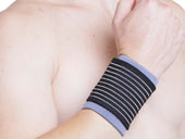 Kedley Active Elasticated Wrist Support worn on right wrist, provides support for sprains, in use view.