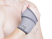 Kedley Pro-Light Neoprene Wrist Support worn on hand, fist raised, plain white background, in use front view.
