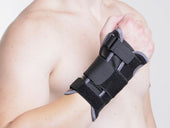 Kedley Aero-Tech Neoprene Wrist Support with metal splint worn on right clenched fist, in use, front view.