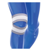 Grey and white elastic knee support wrap on blue mannequin leg, shown in use, side view.