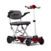 Red aluminium Drive Manual Fold+ scooter with grey seat and puncture proof tyres, shown folded for travel, side view.