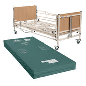 Sidhil Alphalite Low Bed with wood panel ends and mattress behind a green high risk mattress on the floor, front view.