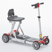 Grey Motion Healthcare mLite folding four-wheel scooter with black seat, white background, side view.